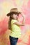 Kid or baby girl in summer t shirt, cowboy hat
