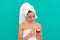 kid in bath tower applying skin cream, face mask