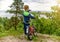 The Kid with a Bike stands high on a hill overlooking the river