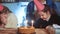 kid birthday. little girl blows out the candles on the cake in a circle of happy family. celebration birthday kid