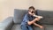 Kid in black glasses plays with a white airplane toy, concept of flight, travel