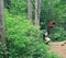 Kid in a blue helmet on a sliding swing. Agility skills and climbing outdoor amusement center for children. Agility