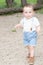 Kid boy 2 year standing on a park background