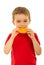 Kid boy biting slice orange