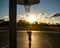 Kid boy concentrated on playing basketball silhouette on sunset.