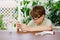 Kid boy doing chemical experiment in laboratory at school. Child with protective glasses study using pipette dropping