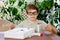 Kid boy doing chemical experiment in laboratory at school. Child with protective glasses study using pipette dropping