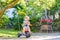 Kid boy driving tricycle or bicycle in garden