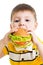 Kid boy eating delicious hamburger isolated