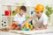 Kid boy and father play builders