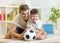 Kid boy and father playing with soccerball indoor