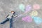 Kid boy having fun with colorful balloons drawing with chalks