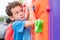 Kid boy having fun to play on children`s climbing toy at school