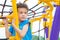 Kid boy having fun to play on children`s climbing toy at school playground,back to school activity.kindergarten preschool