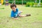 Kid boy having fun to play children`s playground area at school,kid running and fall down on grass.back to school outdoor activit