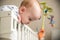 Kid boy infant standing in his bed