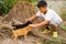 Kid boy playing with stray puppies