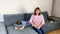 Kid, a boy of primary school age in jeans, a blue shirt lies on the sofa face down, mom sits nearby and scolds her son for