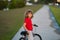 Kid boy riding a bike in summer park. Child drive a bike on a driveway outside. Kid riding bikes. Child on bike outdoor