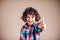 Kid boy shows thumbs up sign and smiles. Children and emotions concept