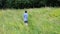 Kid, boy walks among meadows and forests in summer, the concept of a family summer vacation, picnic, vacation, camping, activity