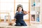 Kid boy weared aviator helmet plays with wooden toy plane in his children room