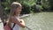 Kid on Bridge at Camping in Mountains Trails, Child Hiking in Excursion, Young Blonde Girl Looking a River, Stream in Nature
