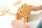 Kid builds wooden house, close up. Child plays with wooden blocks. Small house miniature. Family house concept. Family, home, futu