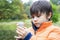 Kid catching creatures in pond, Little boy looking at inect in bug box, Selective focus of Child explorer and learning about wild