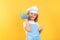 Kid chef cook with cooking bowl. Child wearing cooker uniform and chef hat preparing food on kitchen, studio portrait