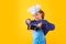 Kid chef cook with cooking pot stockpot. Child wearing cooker uniform and chef hat preparing food on kitchen, studio