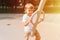 kid on city playground swings on swing carousel. cute little happy smiling candid five