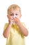 Kid cleaning nose with tissue isolated