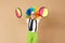 Kid in clown wig and eyeglasses playing catch ball game