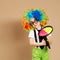 Kid in clown wig and eyeglasses playing catch ball game