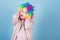 Kid colorful curly wig artificial hair clown style blue background. Circus school concept. Acting school for children