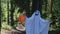 kid in a costume ghost with orange balloon. Halloween celebration holiday. Funny smiling grimace