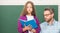 kid and dad in classroom with copybook at blackboard, education