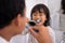 Kid and dad having fun while brushing their teeth