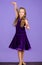 Kid dancer satisfied with concert outfit. Girl cute child wear velvet violet dress. Clothes for ballroom dance. Kids