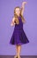 Kid dancer satisfied with concert outfit. Girl cute child wear velvet violet dress. Clothes for ballroom dance. Kids