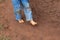 Kid dirty feet on muddy ground