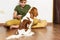 Kid with dog indoor. Teen boy is training her puppy at home. Happy boy playing hugging his funny pet puppy dog domestic