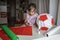 Kid doing pinata with cardboard from used box and color paper, diy decoration at birthday party