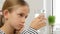 Kid drinking water in kitchen, thirsty teenager girl studying glass of fresh water, children healthcare