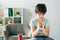 Kid with dyslexia holding wooden building blocks and looking at it