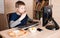 Kid eating pizza and surfing on internet or playing video games