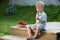 Kid eating strawberries on a sunny deck