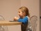 Kid eats flatbread cheese roll in kitchen. Child having dinner. Homemade healthy Shawarma food. Lavash caucasus tandoor