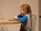 Kid eats flatbread cheese roll in kitchen. Child having dinner. Homemade healthy Shawarma food. Lavash caucasus tandoor
